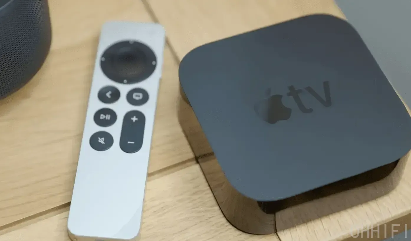 Apple TV 4K and Siri Remote on a wooden table beside a HomePod speaker, the pairing tvOS 27 promises faster AirPlay for