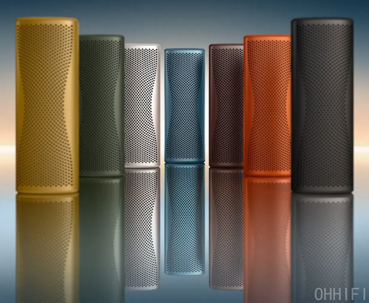 KEF Muo portable Bluetooth speaker in all seven finishes standing vertically in a row on a reflective surface — Amber Haze, Moss Green, Silver Dusk, Blue Aura, Cocoa Brown, Orange Moon and Midnight Black.