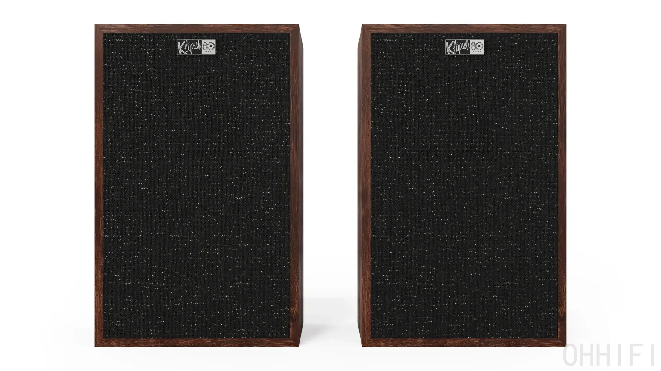 A matched pair of Klipsch Rebellion Heritage bookshelf speakers in grain-matched wood veneer, shown front-on with black cloth grilles on and Klipsch 80th-anniversary badges — a two-way horn-loaded standmount debuting at High End Vienna 2026 at $2,599/pair.