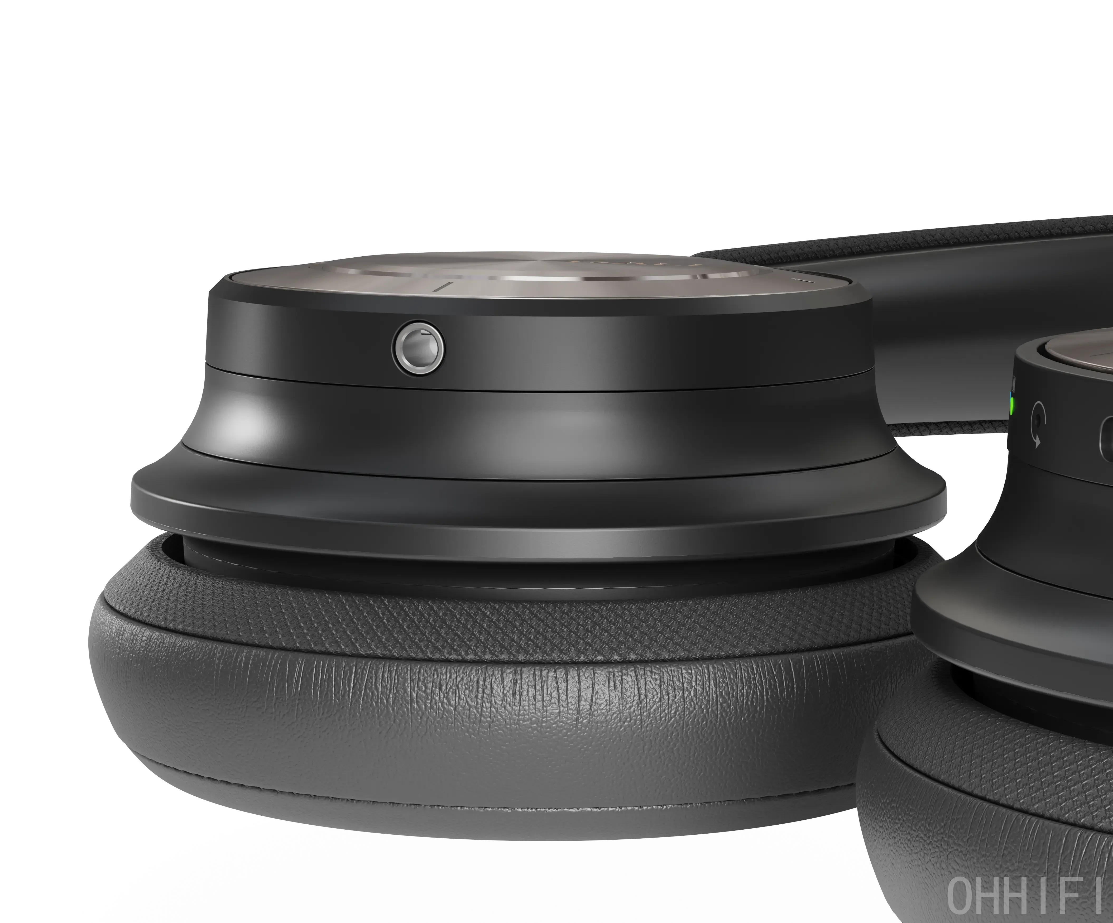 Macro close-up of the DALI IO-8 ear cup in Iron Black, showing the 3.5mm jack for passive wired listening above the stitched leather ear pad.