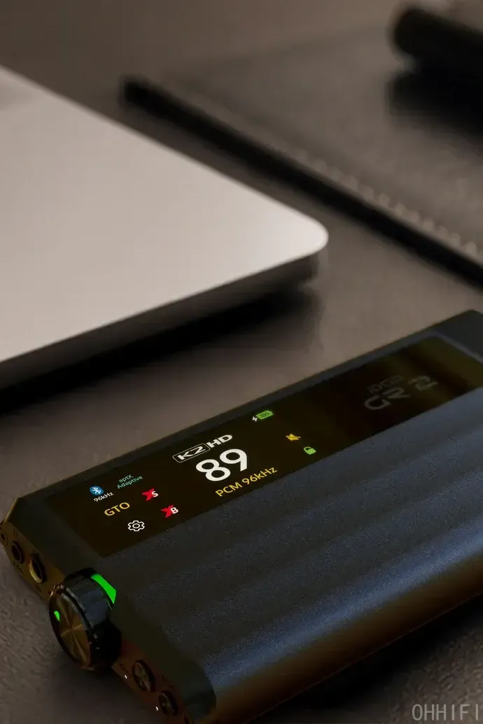 Close-up of the iFi iDSD GR 2 touchscreen showing K2HD, 96kHz PCM and volume, with its green-ringed volume knob.