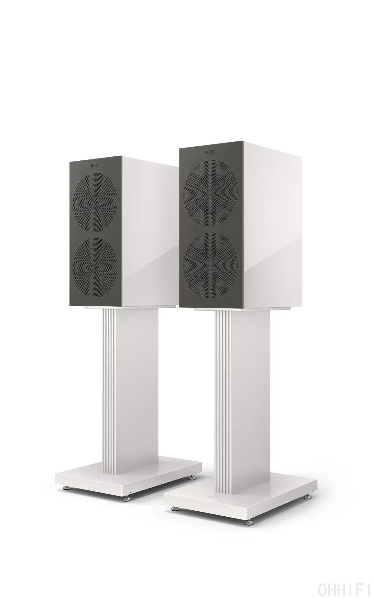 KEF two-way bookshelf speakers pair in gloss white finish with perforated grilles, mounted on matching fluted white speaker stands